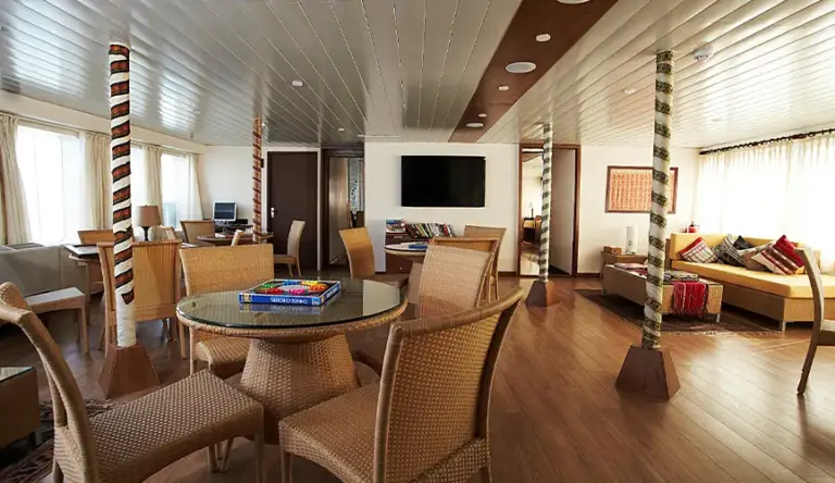 Interior of a modern lounge with seating and a dining table.