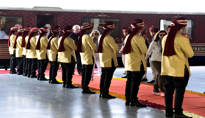 Staff lined up welcoming passengers at a train station.