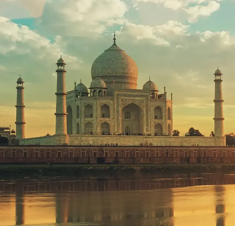 The Taj Mahal at sunset reflecting in the Yamuna River.