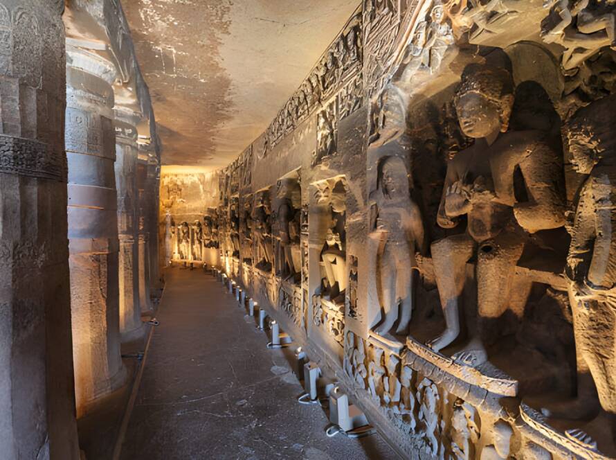 Ancient rock-cut sculptures and illuminated corridor at Ajanta and Ellora Caves, representing Iconic Monuments in India.