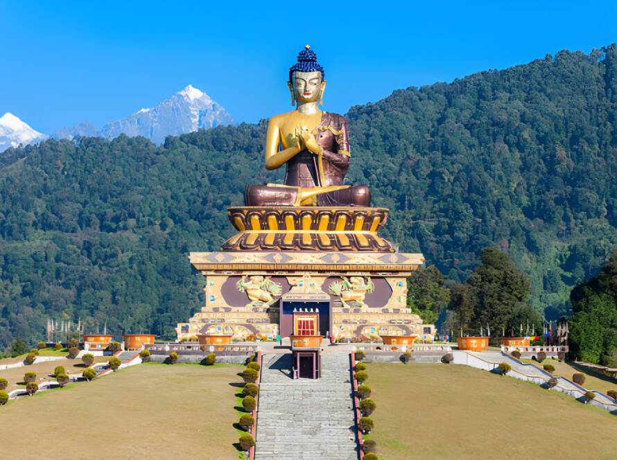 Massive Buddha statue at Buddha Park in Ravangla, framed by lush hills and snowy peaks, representing the Best Hill Stations in India.