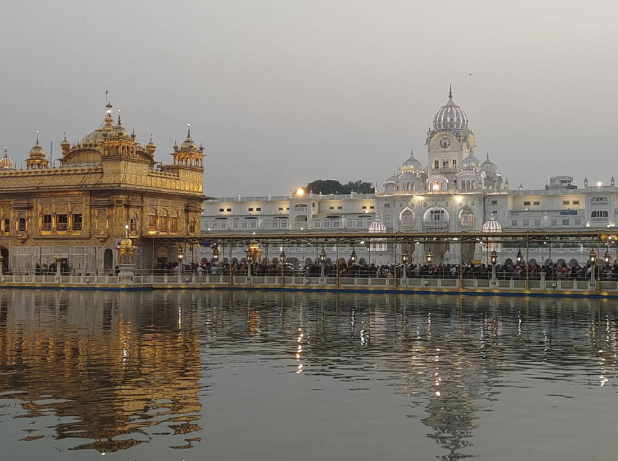 Golden Temple Amritsar: Sacred Sikh shrine with gilded dome reflected in holy Amrit Sarovar pool surrounded by marble structures