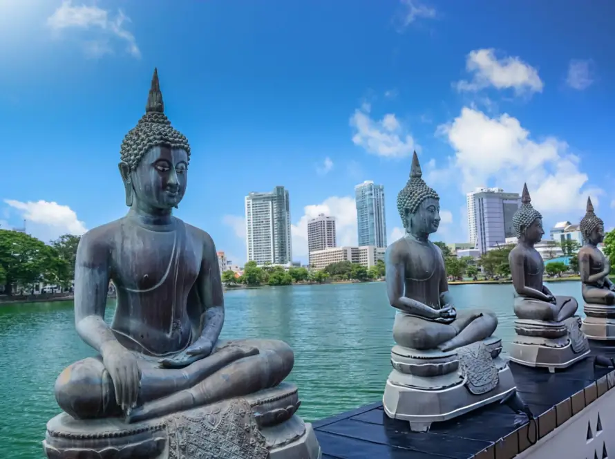 Buddha statues by the water in Colombo, Sri Lanka, showcasing the serene beauty of South Asian Gems with a modern city backdrop