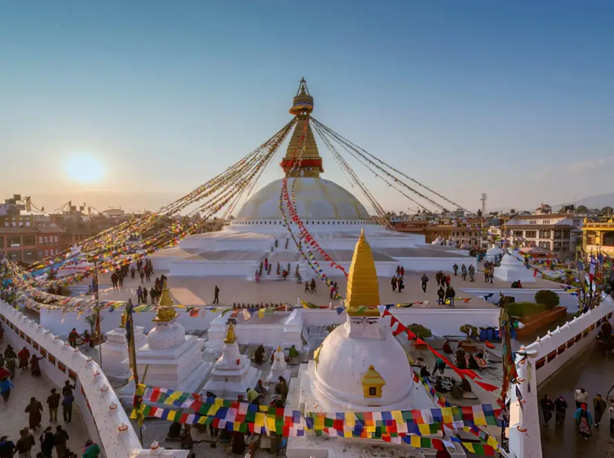 The iconic Boudhanath Stupa in Kathmandu, Nepal, adorned with colorful prayer flags, representing the spiritual heritage of South Asian Gems.