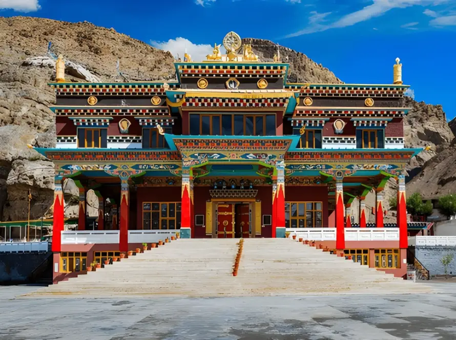 The ornate, brightly colored main building of a Buddhist monastery (likely Dhankar or Tabo) in Spiti Valley, Himachal Pradesh, set against arid mountains, representing Underrated Places in India.